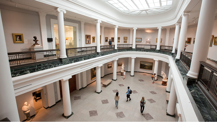 Two people sitting at a table reviewing and discussing documents.